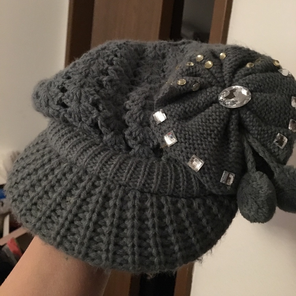 Knit hat with gem on it.